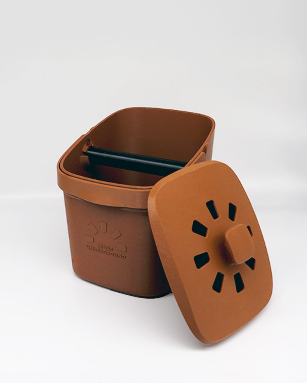 Unique brown compost bin with a lid on a light gray background.